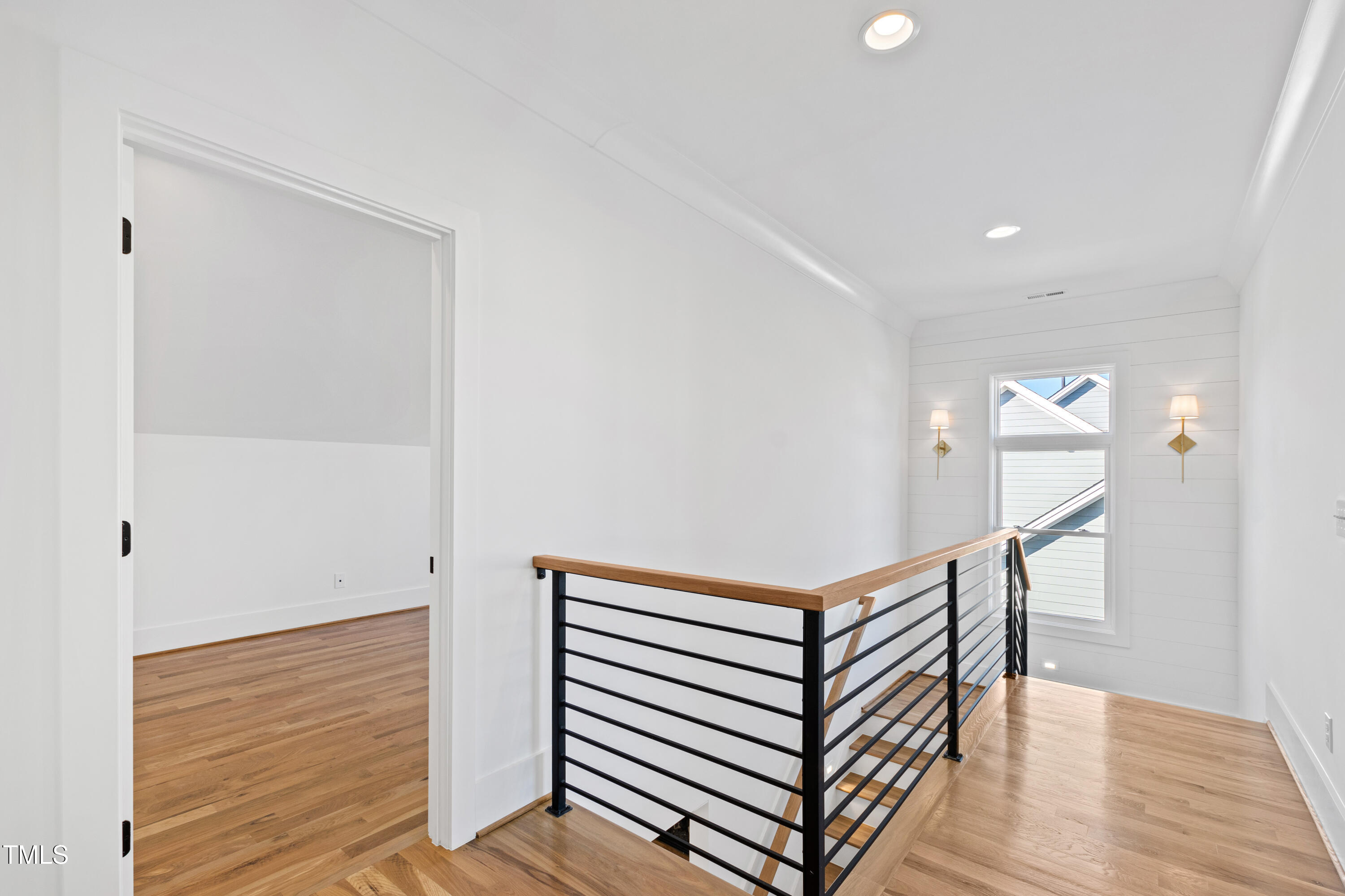920 Lily Claire Lane Fuquay-Varina, NC 27526 - Photo 33 of 62 a view of a hallway with wooden floor and stairs