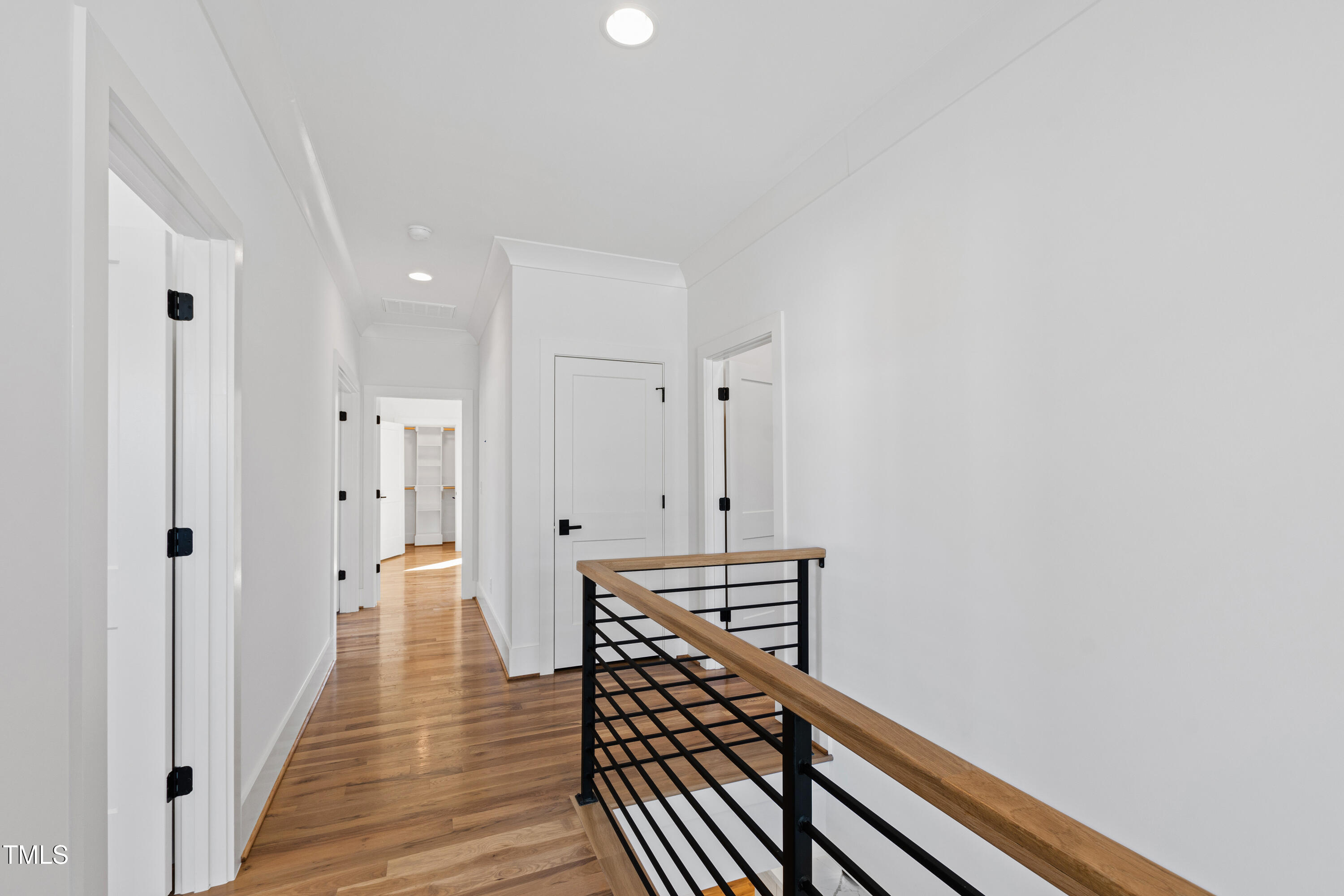 920 Lily Claire Lane Fuquay-Varina, NC 27526 - Photo 34 of 62 a view of a hallway with wooden floor and staircase
