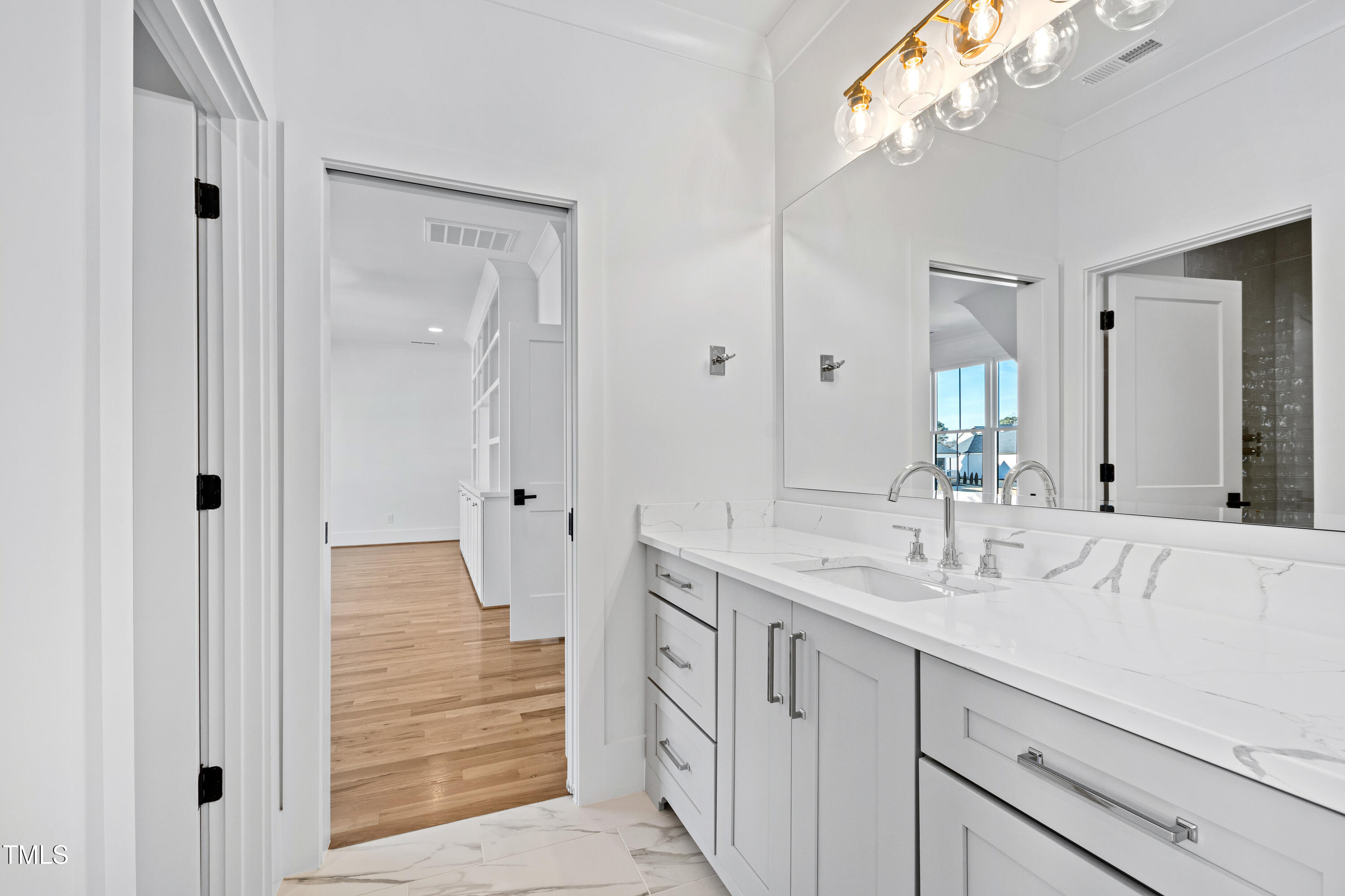 920 Lily Claire Lane Fuquay-Varina, NC 27526 - Photo 37 of 62 a bathroom with a double vanity sink and mirror