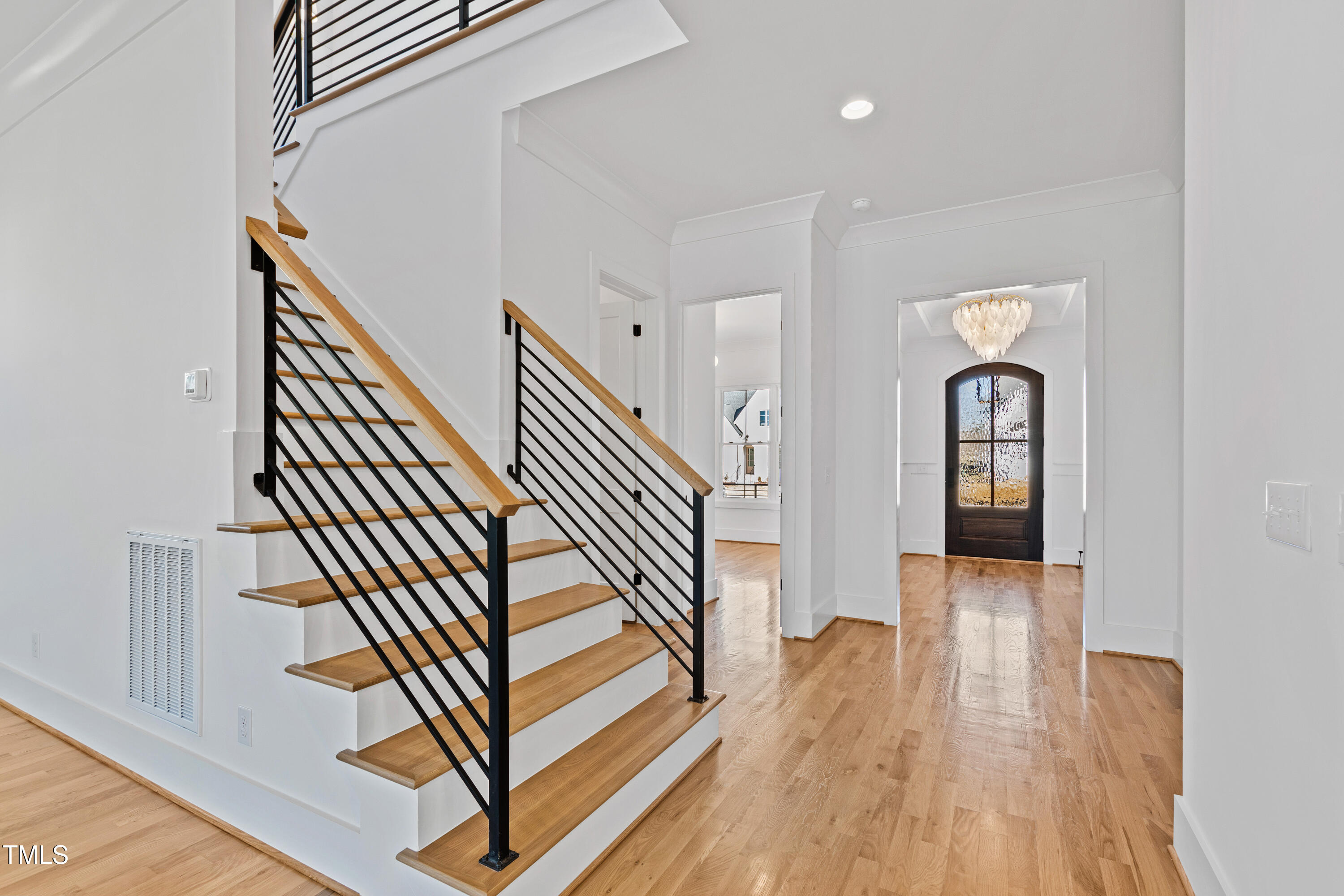 920 Lily Claire Lane Fuquay-Varina, NC 27526 - Photo 5 of 62 a view of a hallway with wooden floor and stairs