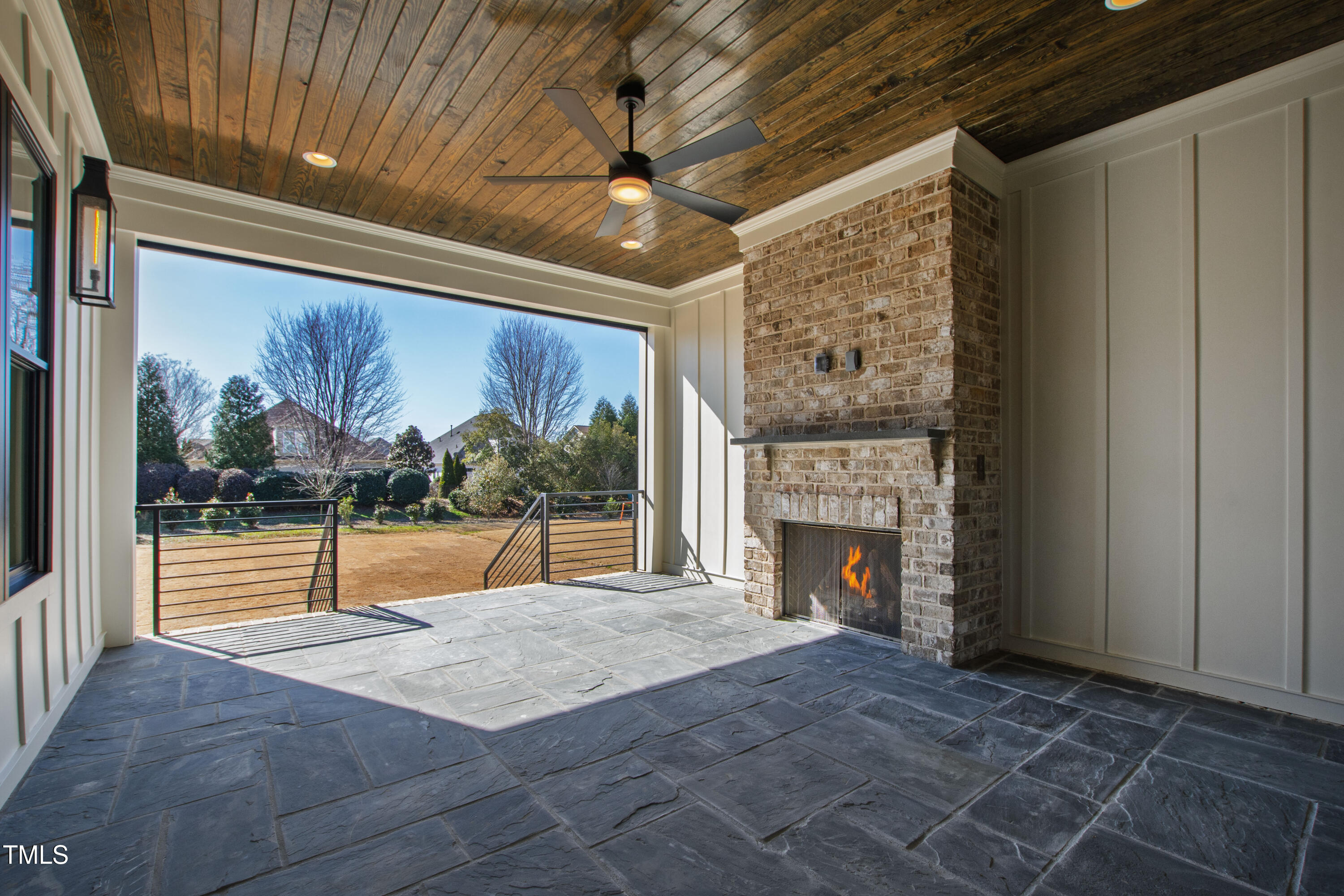 920 Lily Claire Lane Fuquay-Varina, NC 27526 - Photo 56 of 62 a view of an empty room with wooden floor and fireplace