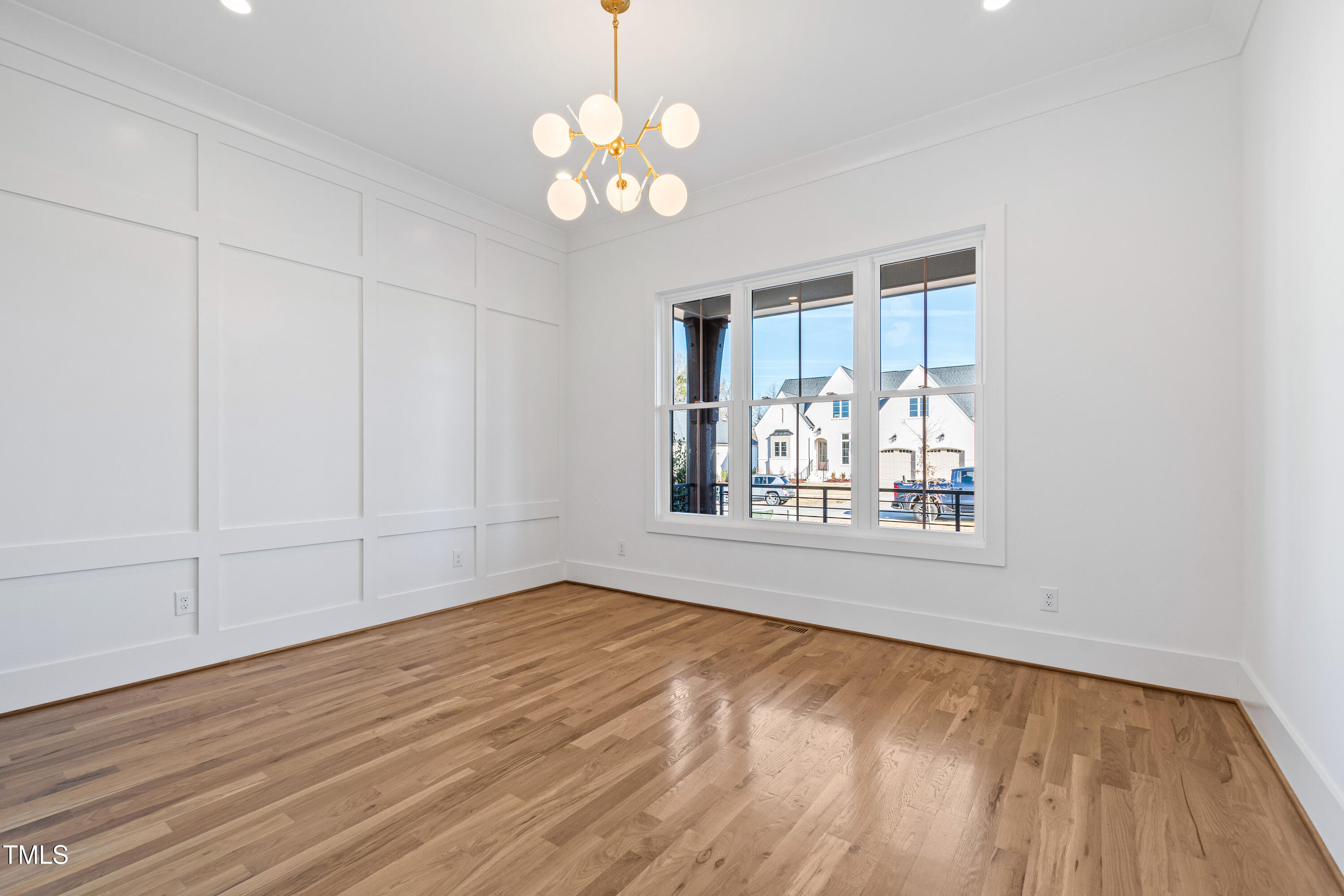 920 Lily Claire Lane Fuquay-Varina, NC 27526 - Photo 6 of 62 a view of an empty room with wooden floor and a window