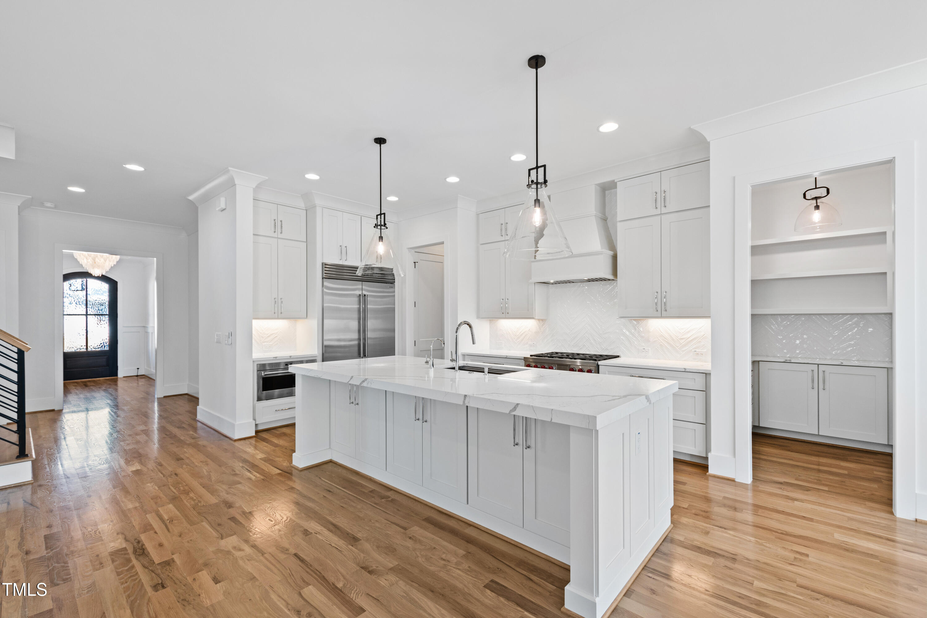 920 Lily Claire Lane Fuquay-Varina, NC 27526 - Photo 8 of 62 a kitchen with a stove a refrigerator and a wooden floor