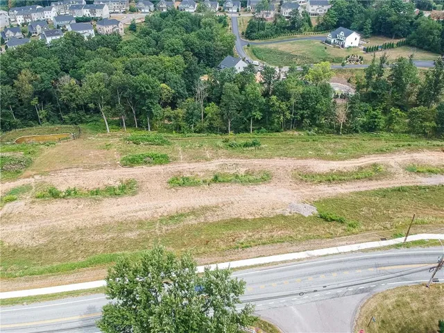 a view of a lake with a yard and large trees