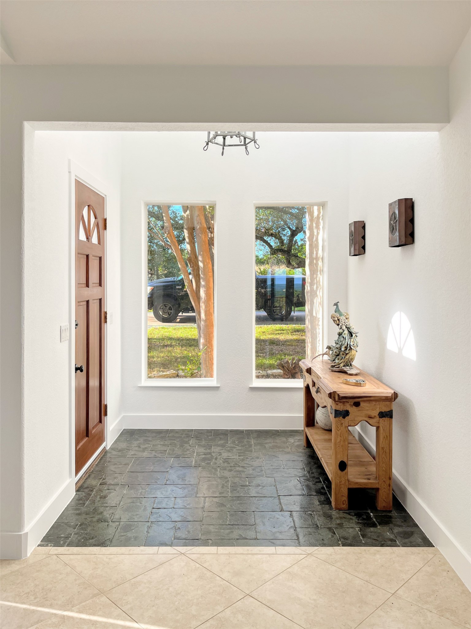 1015 Westland Ridge Road Dripping Springs, TX 78620 - Photo 4 of 32 A welcoming entryway with natural light and a blend of tile flooring.