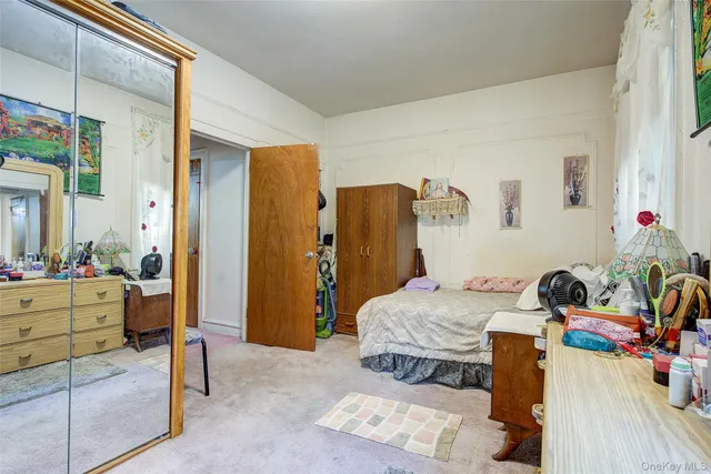 a bedroom with a bed and a dresser in it