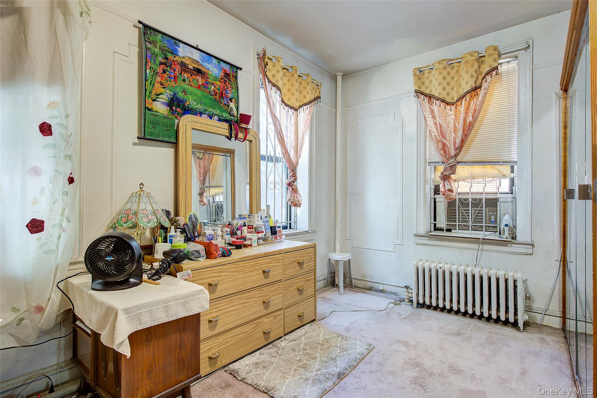 41-41 41st Street, Unit 1G Queens, NY 11104 - Photo 14 of 29 a room that has a dresser and a window