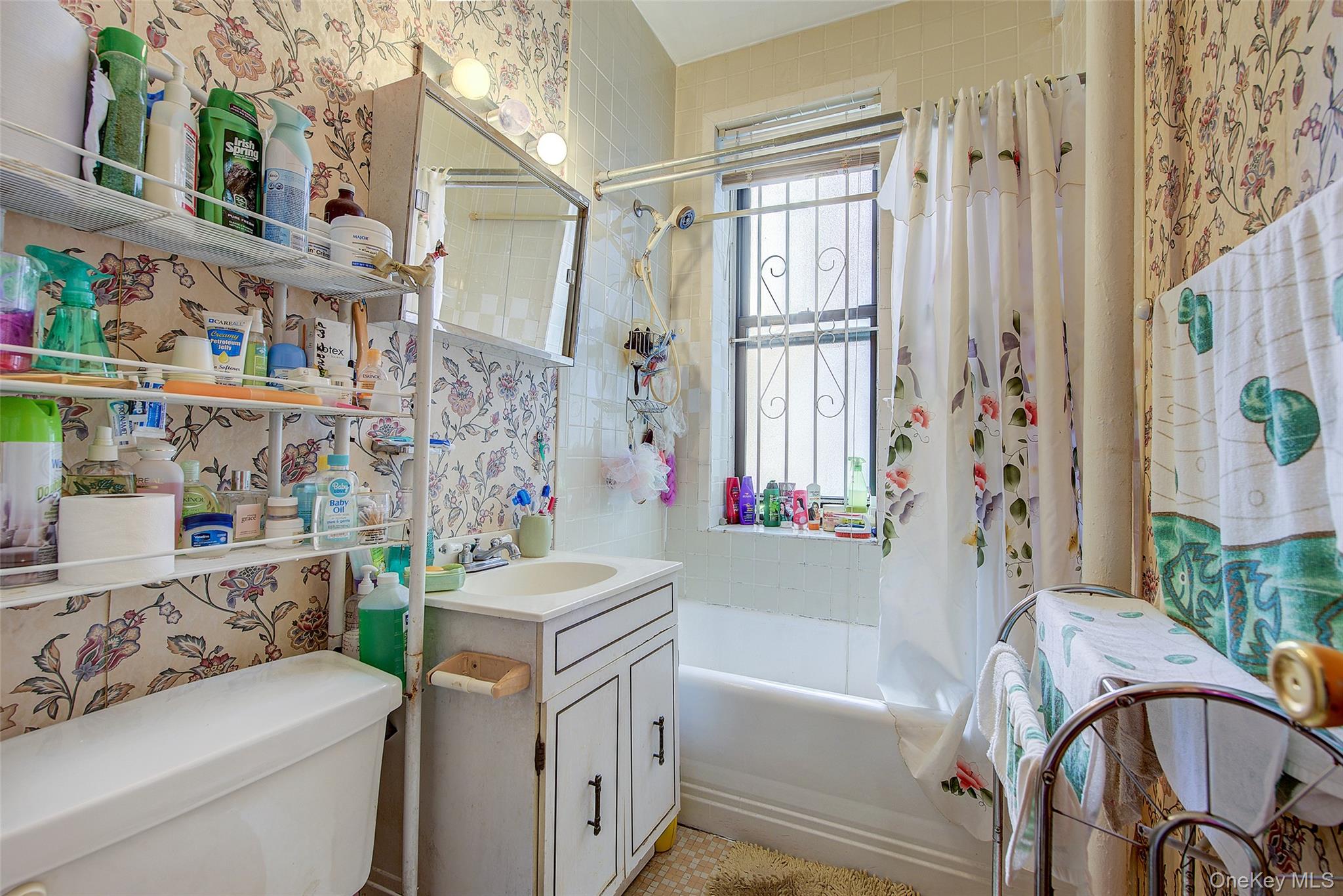 41-41 41st Street, Unit 1G Queens, NY 11104 - Photo 16 of 29 a bathroom with a sink a toilet and a bathtub