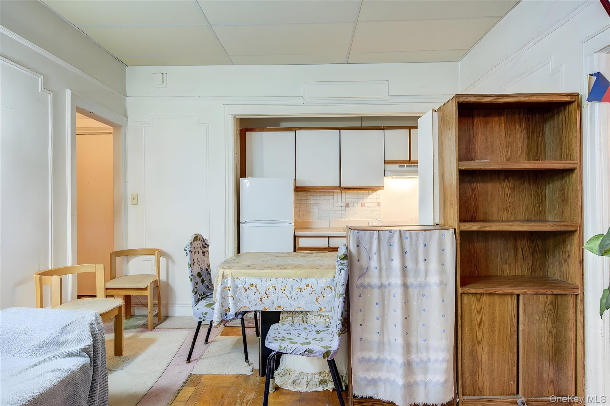 41-41 41st Street, Unit 1G Queens, NY 11104 - Photo 2 of 29 a living room with furniture and a fireplace