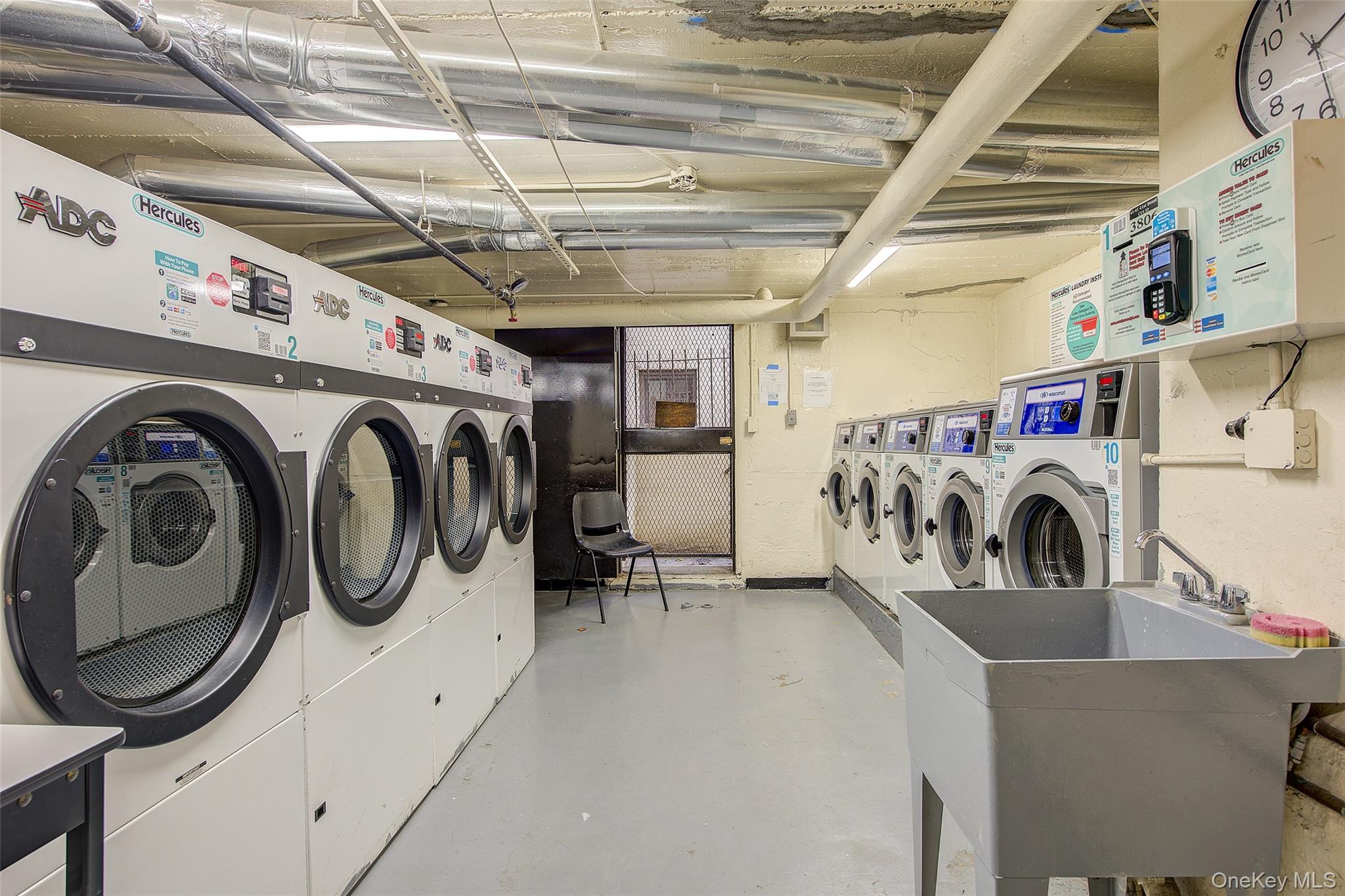 41-41 41st Street, Unit 1G Queens, NY 11104 - Photo 26 of 29 a utility room with dryer and washer