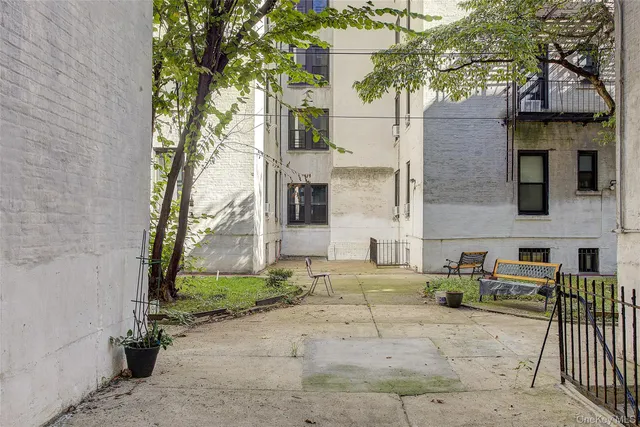 a view of a brick house with many windows