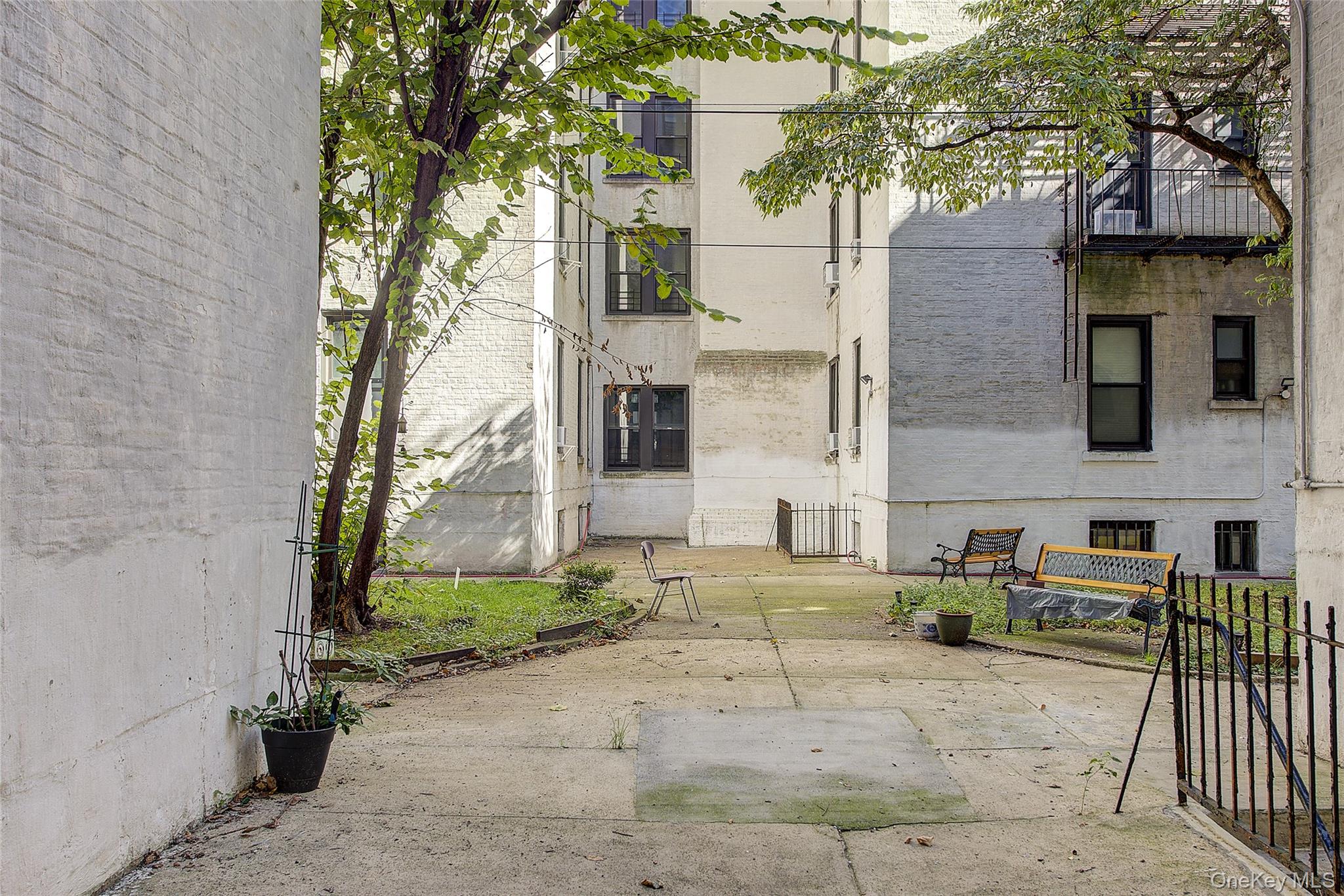 41-41 41st Street, Unit 1G Queens, NY 11104 - Photo 27 of 29 a view of a brick house with many windows