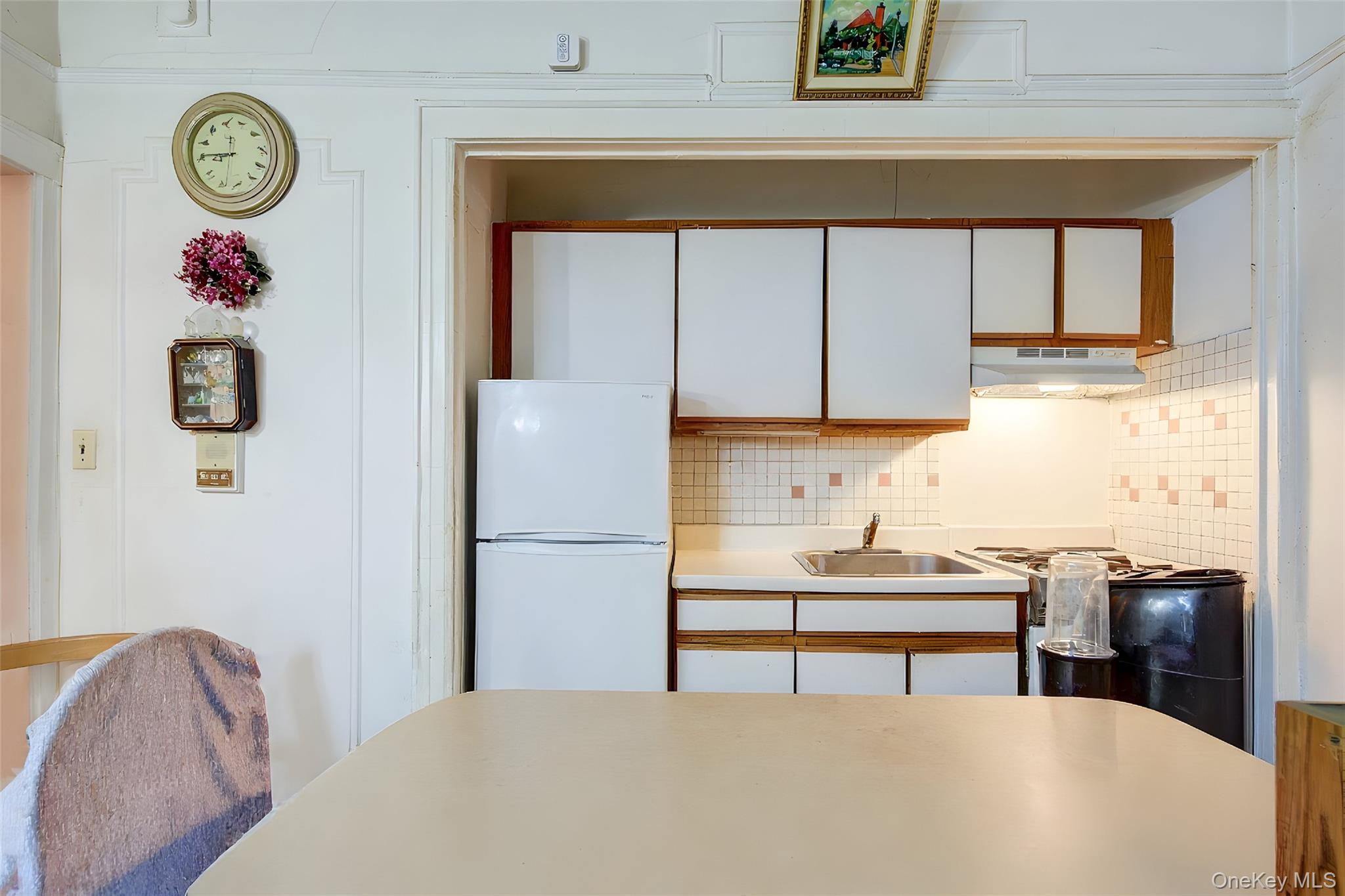 41-41 41st Street, Unit 1G Queens, NY 11104 - Photo 3 of 29 a bedroom with a bed and a chandelier