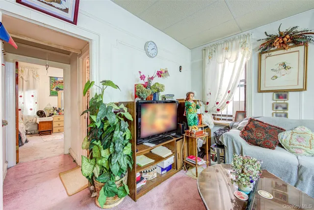 a living room filled with furniture and a flat screen tv