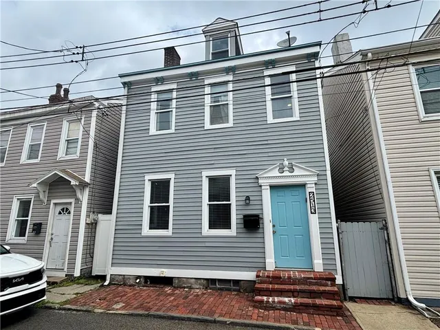 a front view of a house with stairs