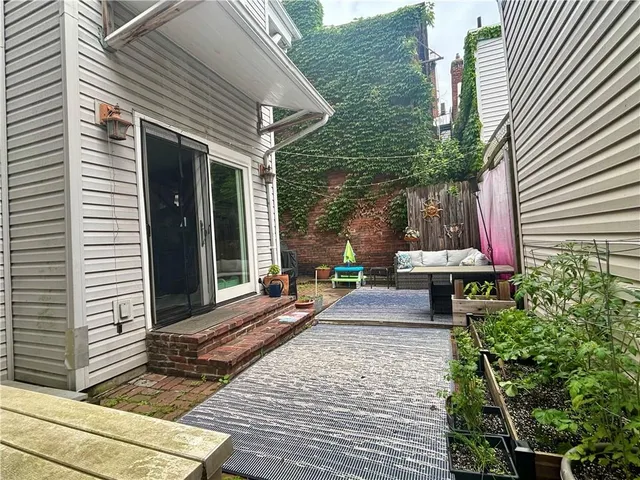 a front view of a house with sitting area