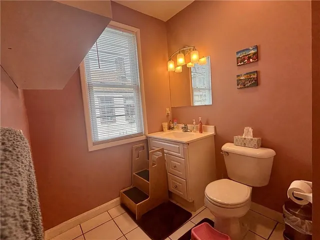 a white toilet sitting next to a bathroom sink