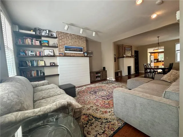 a living room with furniture cabinets and a book shelf