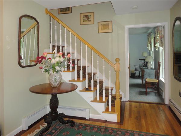 63 Stone Ridge Drive Northampton, MA 01062 - Photo 5 of 26 a view of a hallway with wooden floor and a dining room