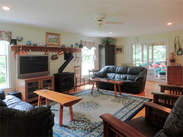 63 Stone Ridge Drive Northampton, MA 01062 - Photo 8 of 26 a living room with furniture a flat screen tv and a fireplace