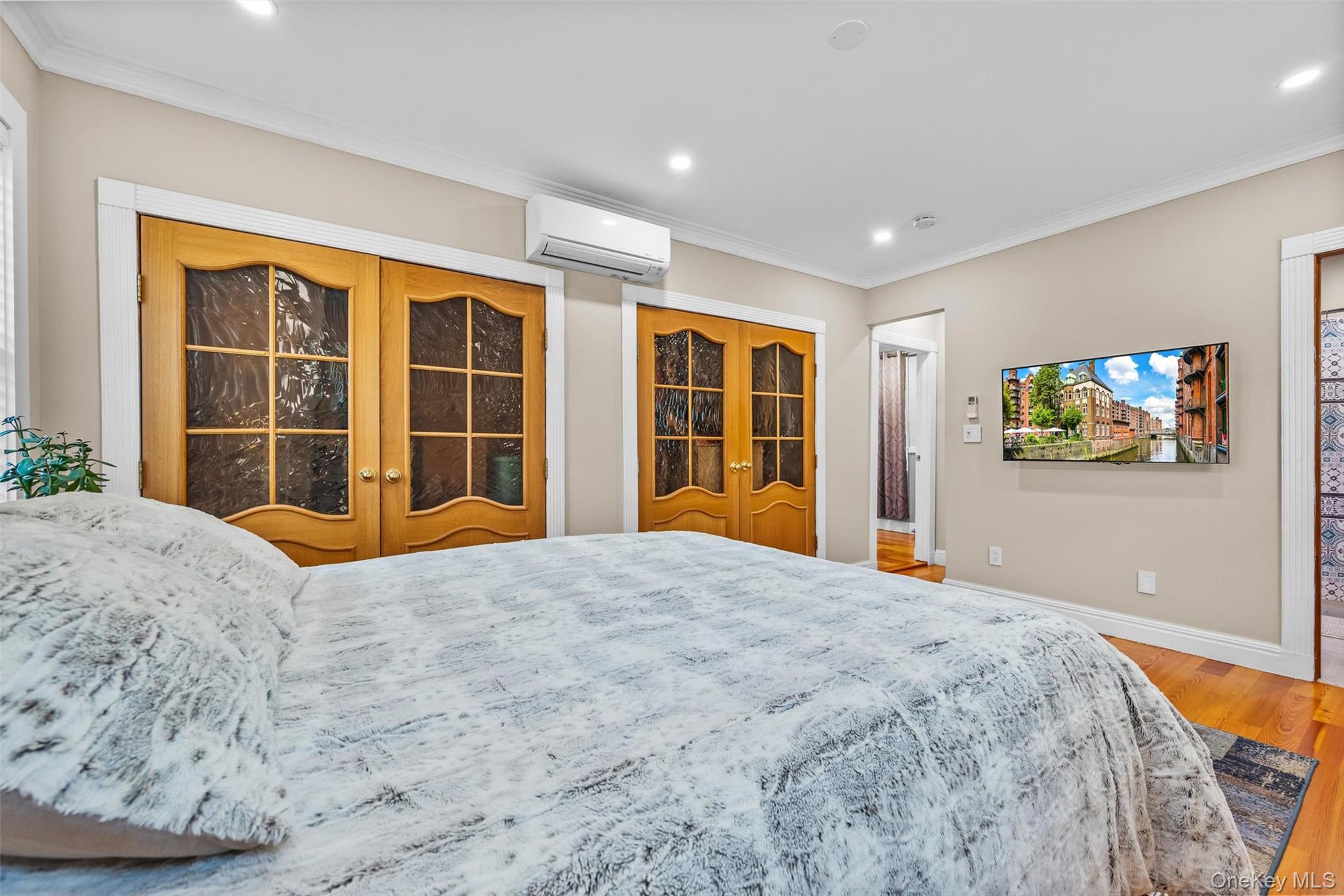 751 Rte 9W Fort Montgomery, NY 10922 - Photo 24 of 41 a bedroom with a bed and a flat screen tv