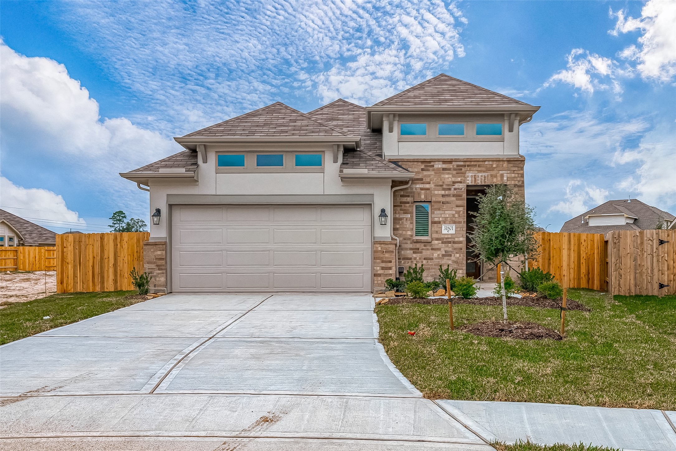 31801 Pecan Cottage Lane Spring, TX 77386 - Photo 1 of 37 a front view of a house with a yard and garage
