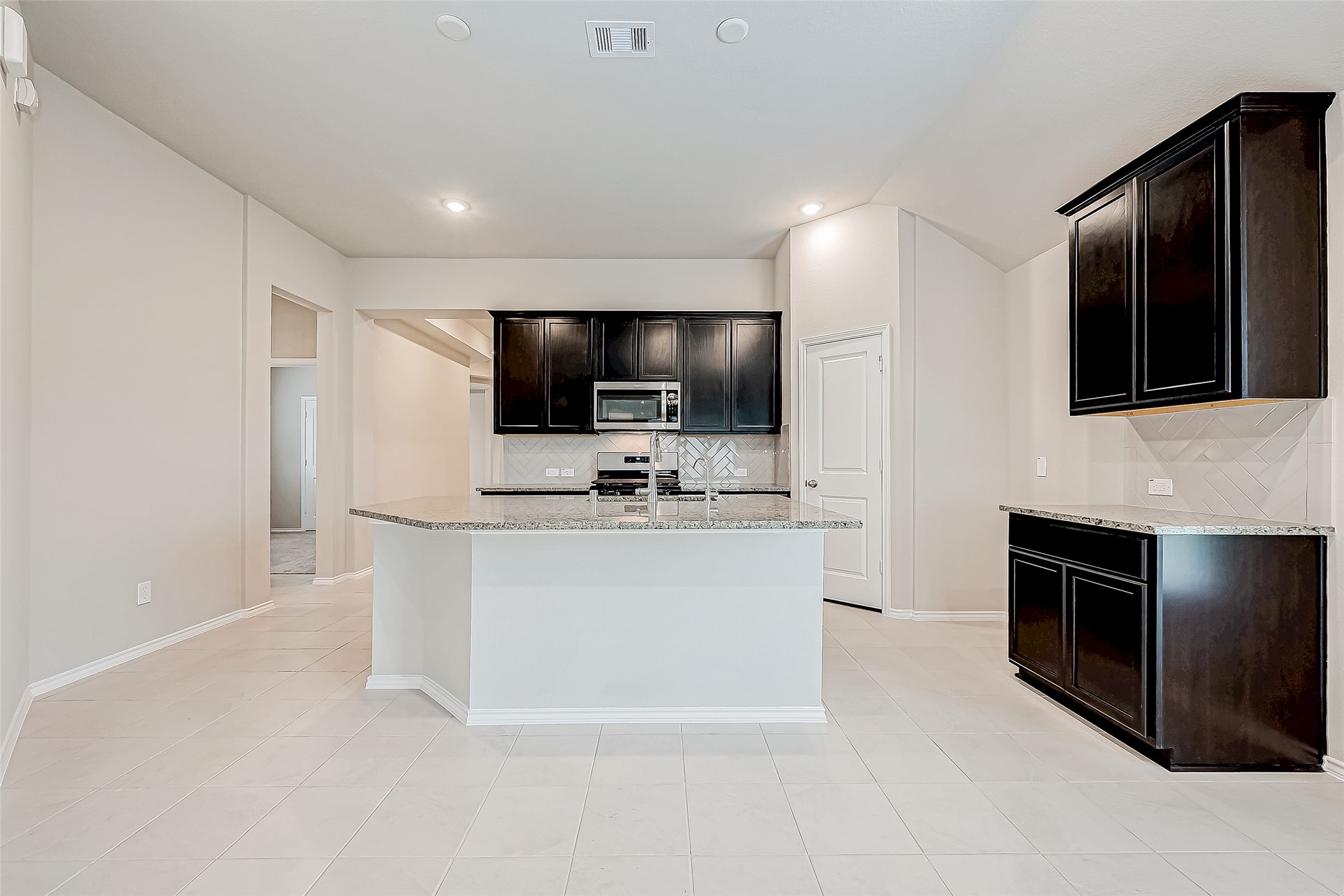 31801 Pecan Cottage Lane Spring, TX 77386 - Photo 12 of 37 a view living room with stainless steel appliances kitchen island microwave and stove