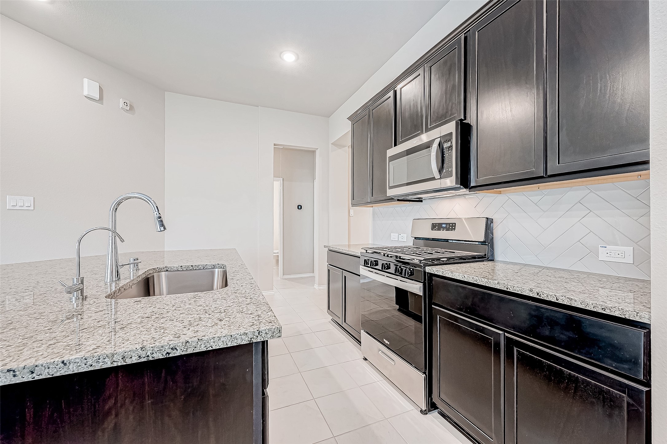 31801 Pecan Cottage Lane Spring, TX 77386 - Photo 17 of 37 a kitchen with stainless steel appliances granite countertop a sink and stove