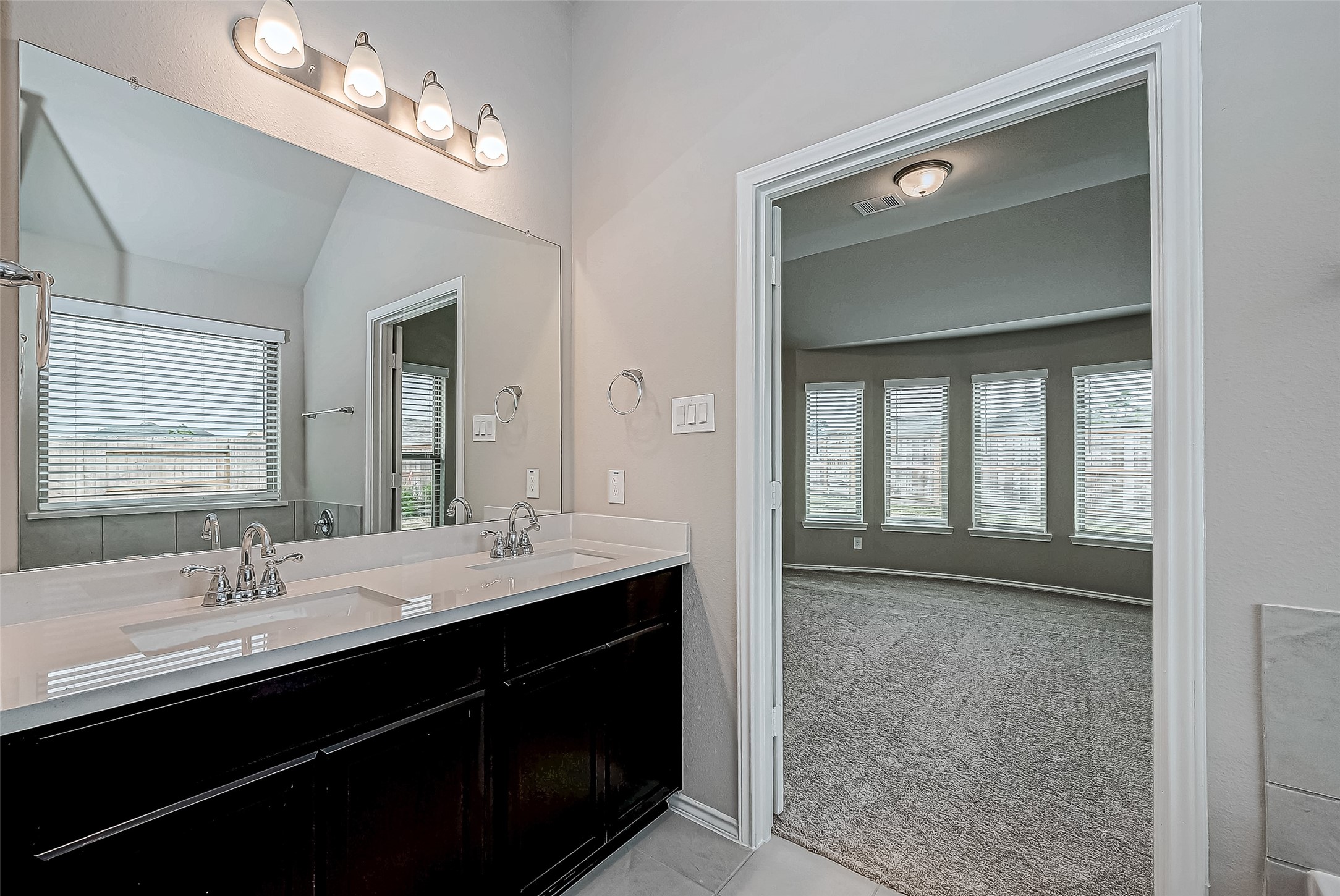 31801 Pecan Cottage Lane Spring, TX 77386 - Photo 29 of 37 a bathroom with a double vanity sink a mirror and a shower
