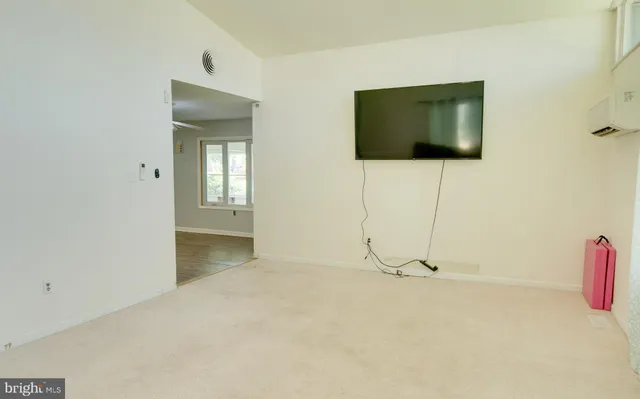 a view of a livingroom with wooden floor and a flat screen tv
