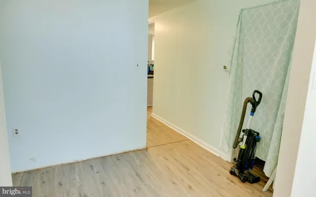 a view of a room with wooden floor and bathroom
