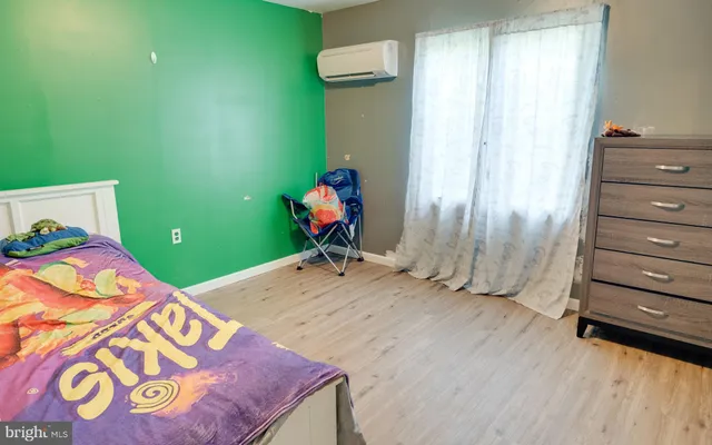 a bedroom with a bed and a dresser