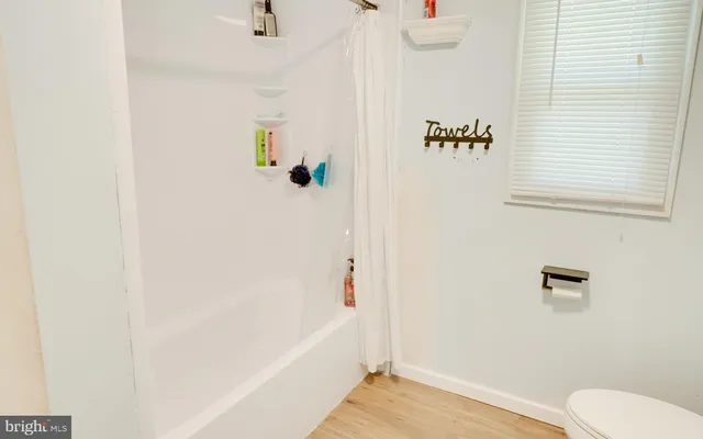 a bathroom with a shower and a sink