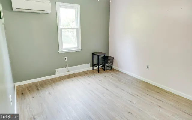 a room with a window and a wooden floor