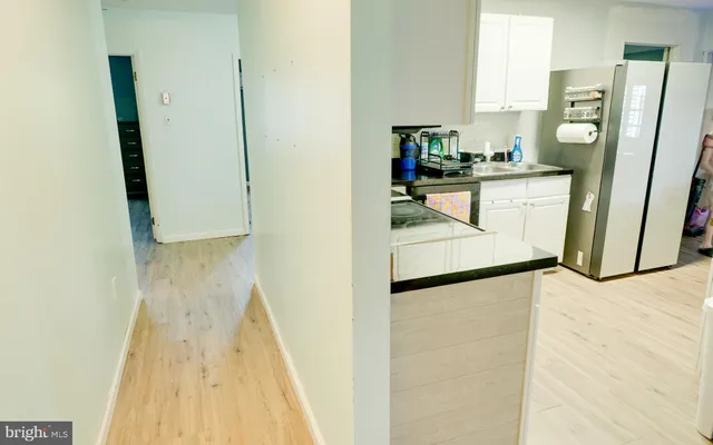 a kitchen with a refrigerator a stove top oven a counter space and a window