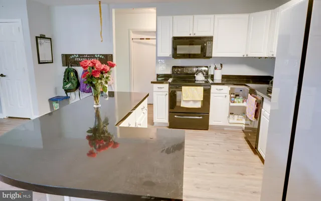 a kitchen with stainless steel appliances a stove a microwave and a refrigerator