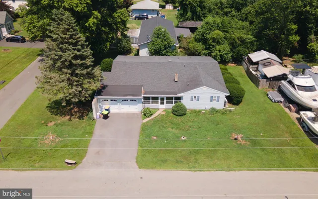 an aerial view of a house with yard