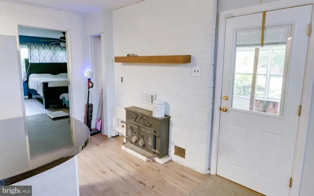 a view of a hallway with wooden floor fireplace and living room
