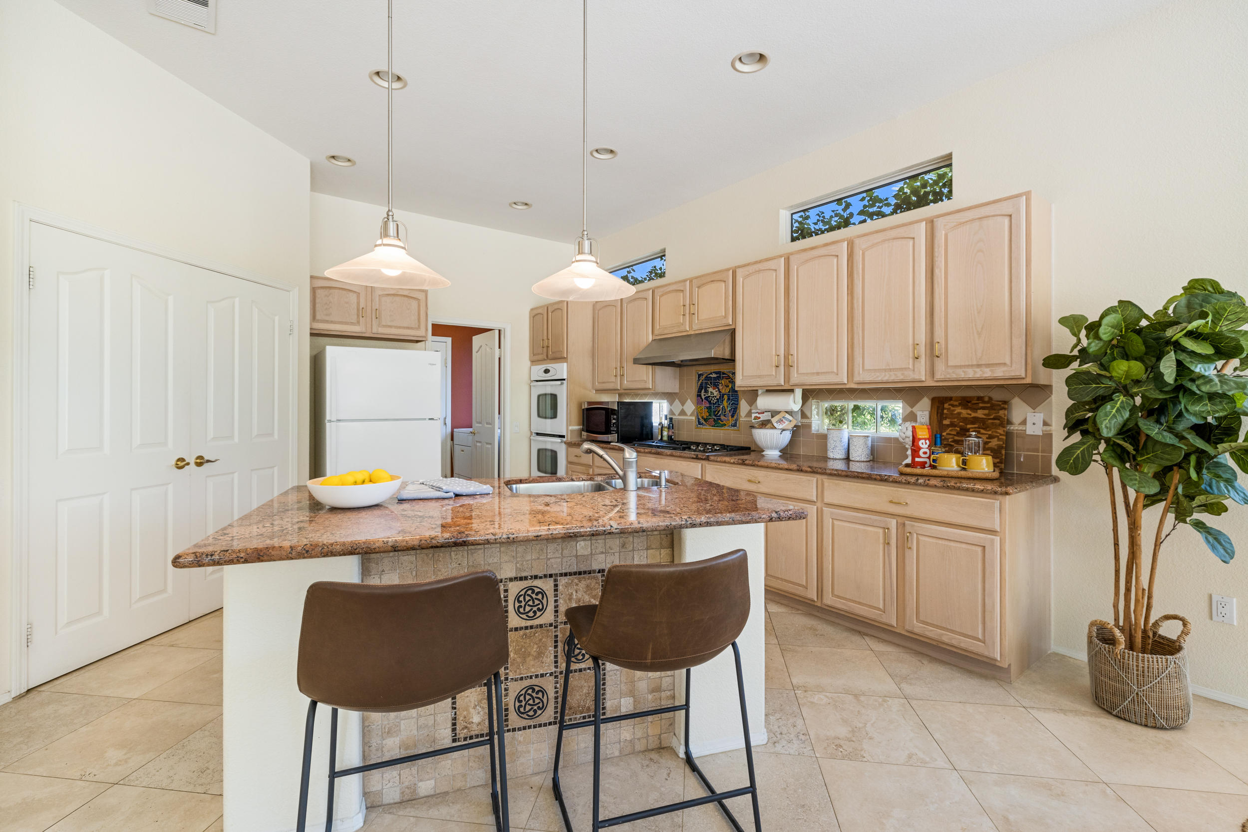 44410 Royal Lytham Drive Indio, CA 92201 - Photo 13 of 72 a kitchen with a sink a counter and cabinets