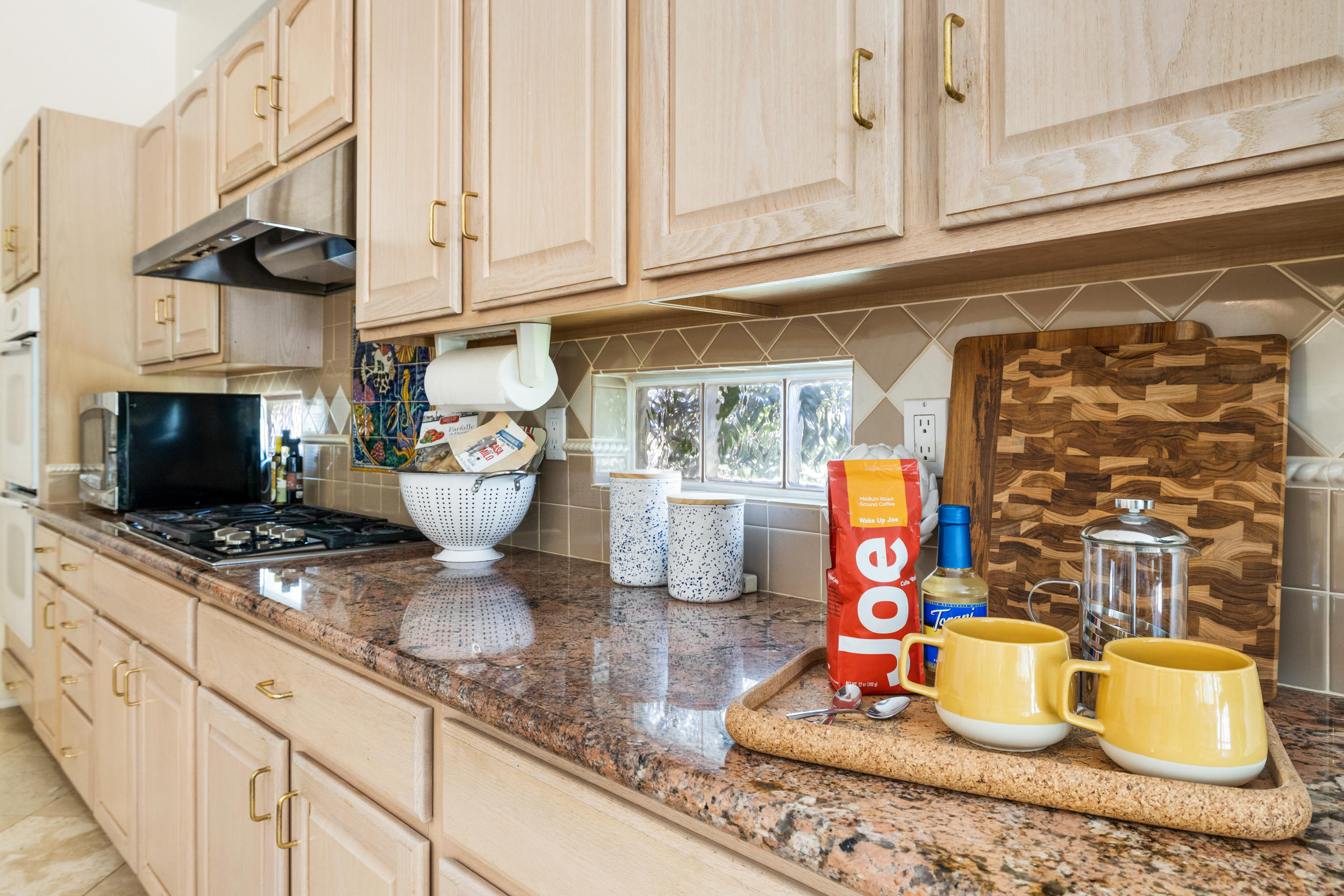 44410 Royal Lytham Drive Indio, CA 92201 - Photo 16 of 72 a kitchen with granite countertop lots of clutter and stainless steel appliances