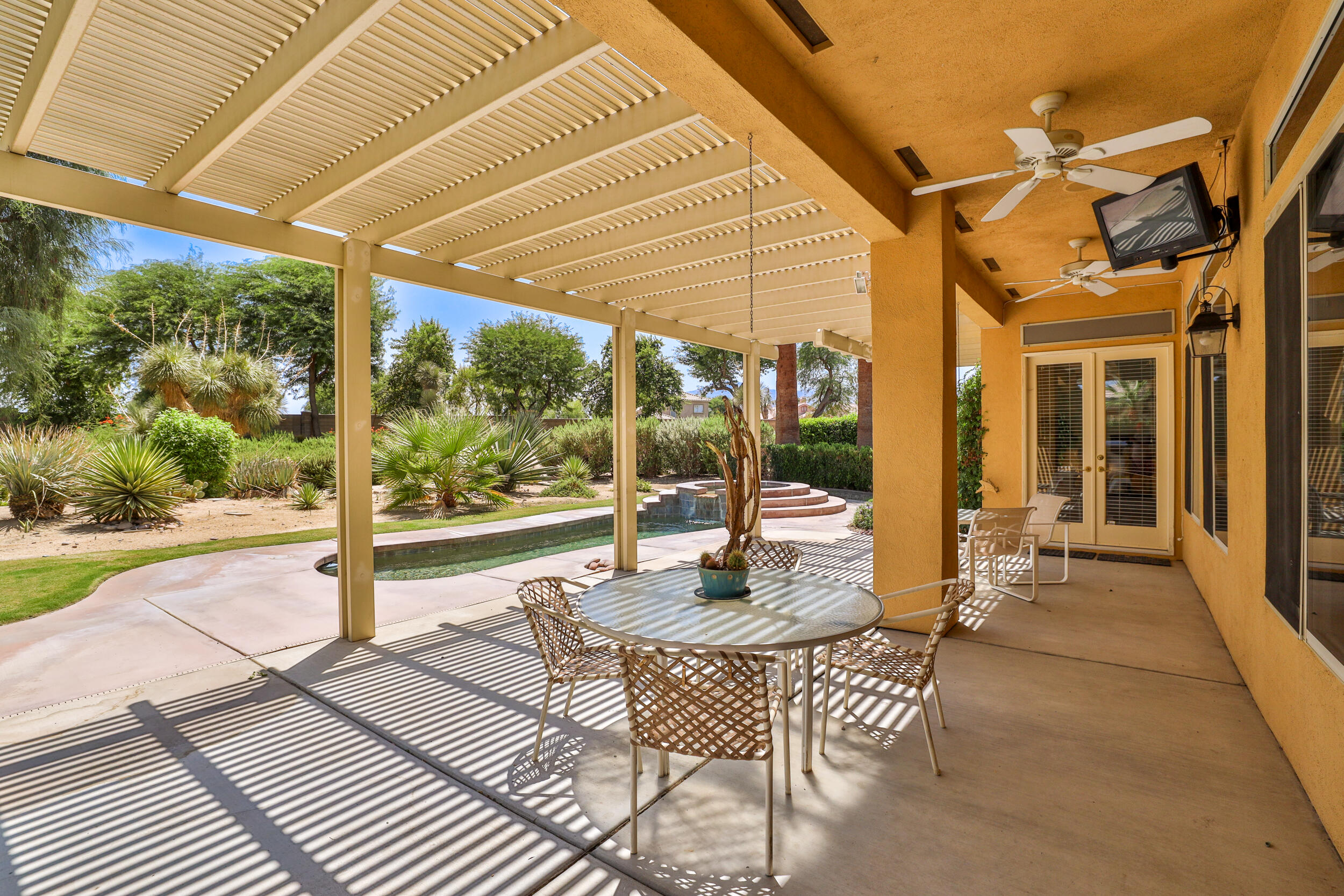 44410 Royal Lytham Drive Indio, CA 92201 - Photo 35 of 72 a view of a patio with a table chairs and backyard