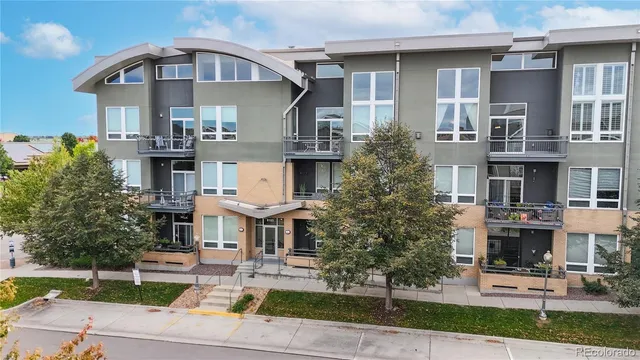 a front view of a residential apartment building with a yard