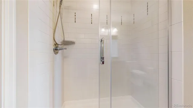a bathroom with a glass shower door