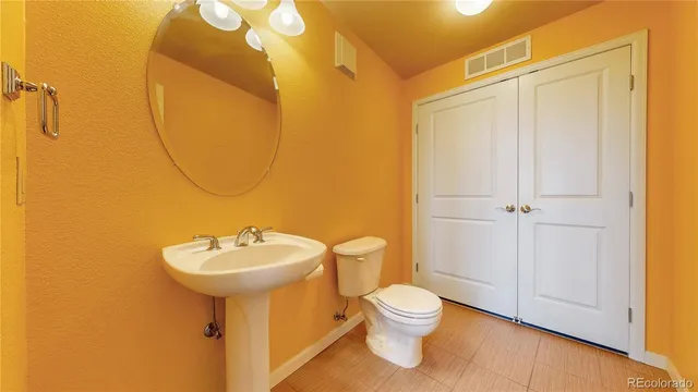 a bathroom with a sink mirror and toilet
