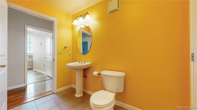 a white toilet sitting next to a bathroom sink