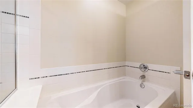 a white bath tub and shower in it