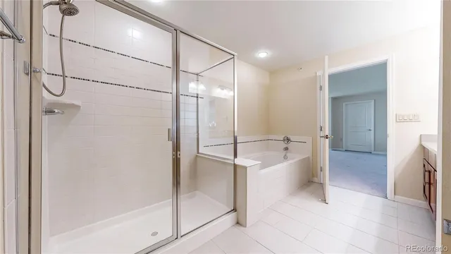 a spacious bathroom with a bathtub and a shower