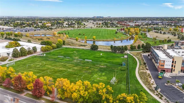 an aerial view of residential houses with outdoor space and swimming pool