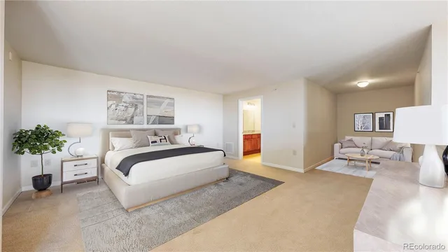 a spacious bedroom with a bed and a potted plant