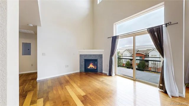 a view of an empty room with a fireplace and a window